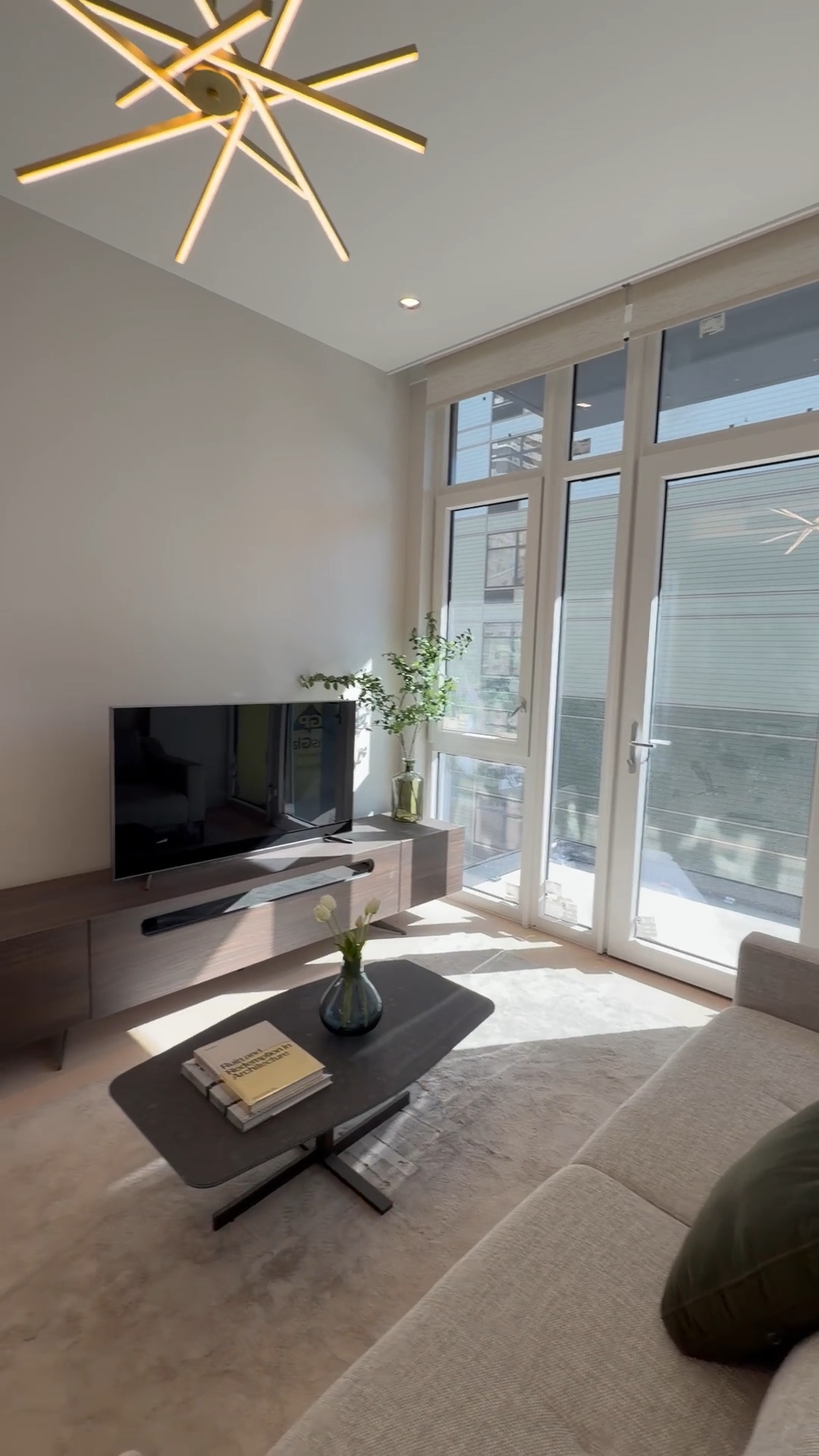 Cream sofa, walnut console, and brass pendant in the living room